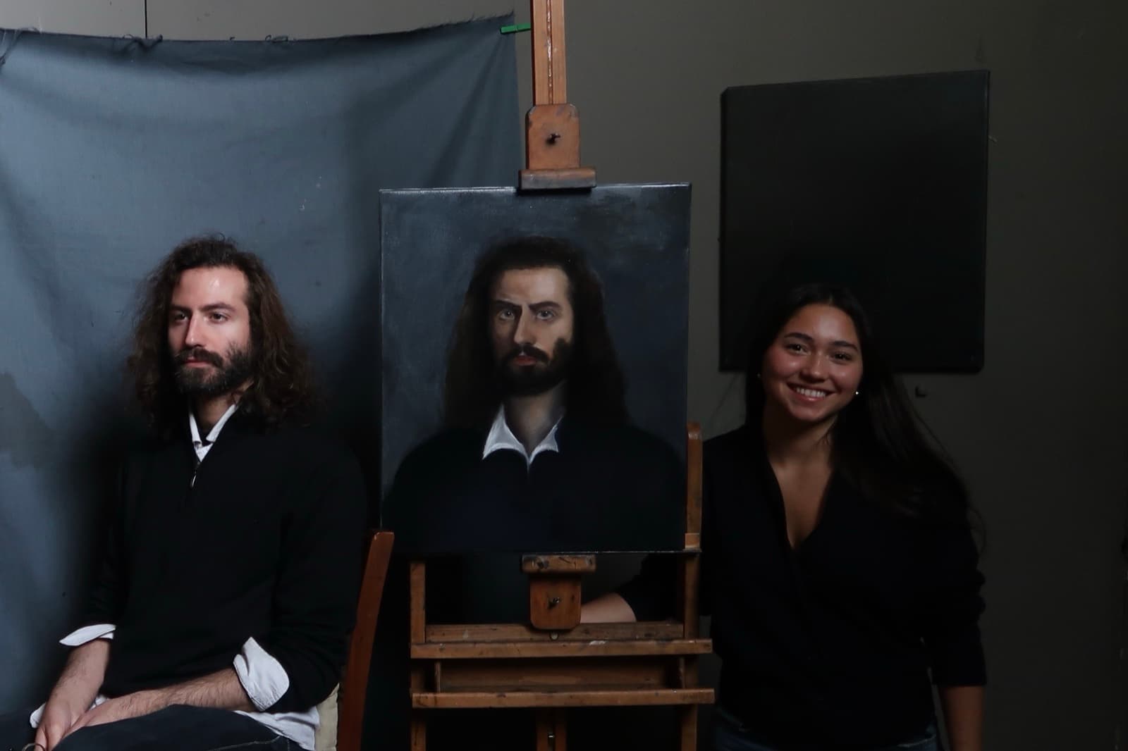 Valery beside a painter and his portrait in a studio